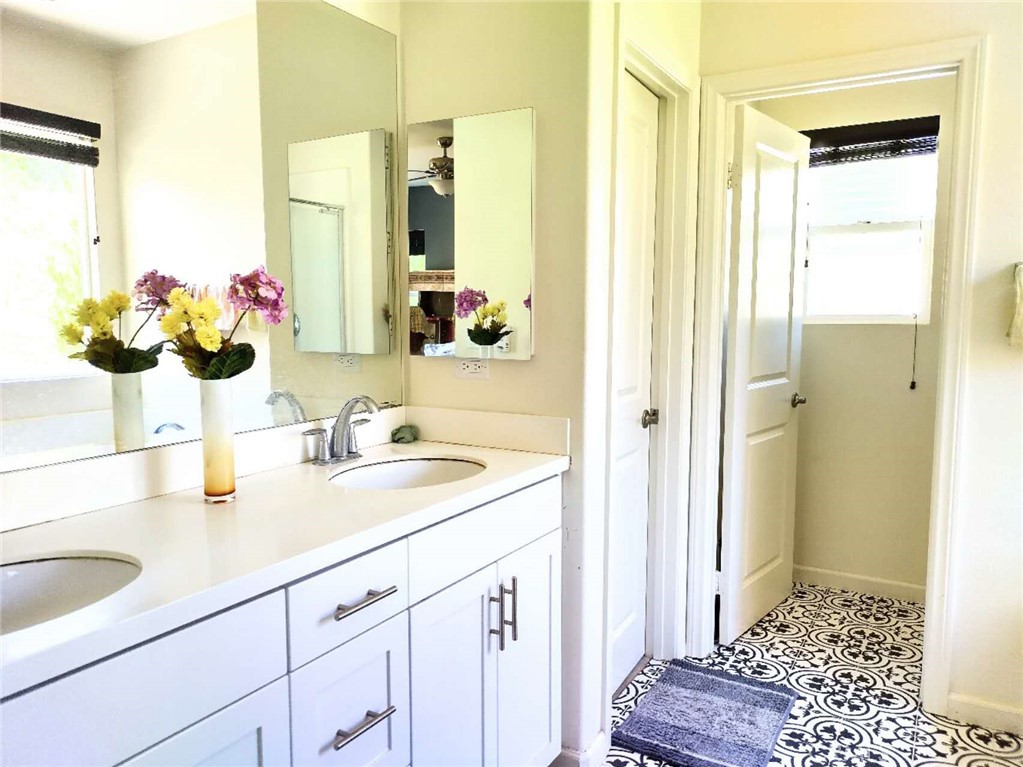 11811 Cramer Road Yucaipa, CA 92399 - Photo 23 of 56 a bathroom with a sink a vanity and a mirror