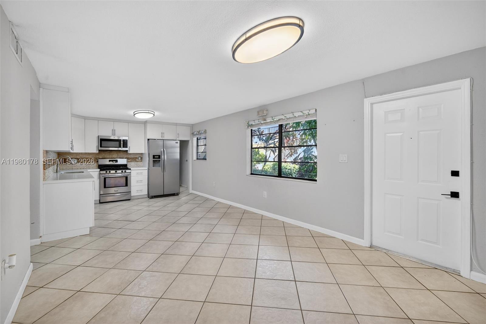 3265 Virginia Street, Unit 9 Miami, FL 33133 - Photo 14 of 32 a view of a kitchen with a sink dishwasher and a refrigerator