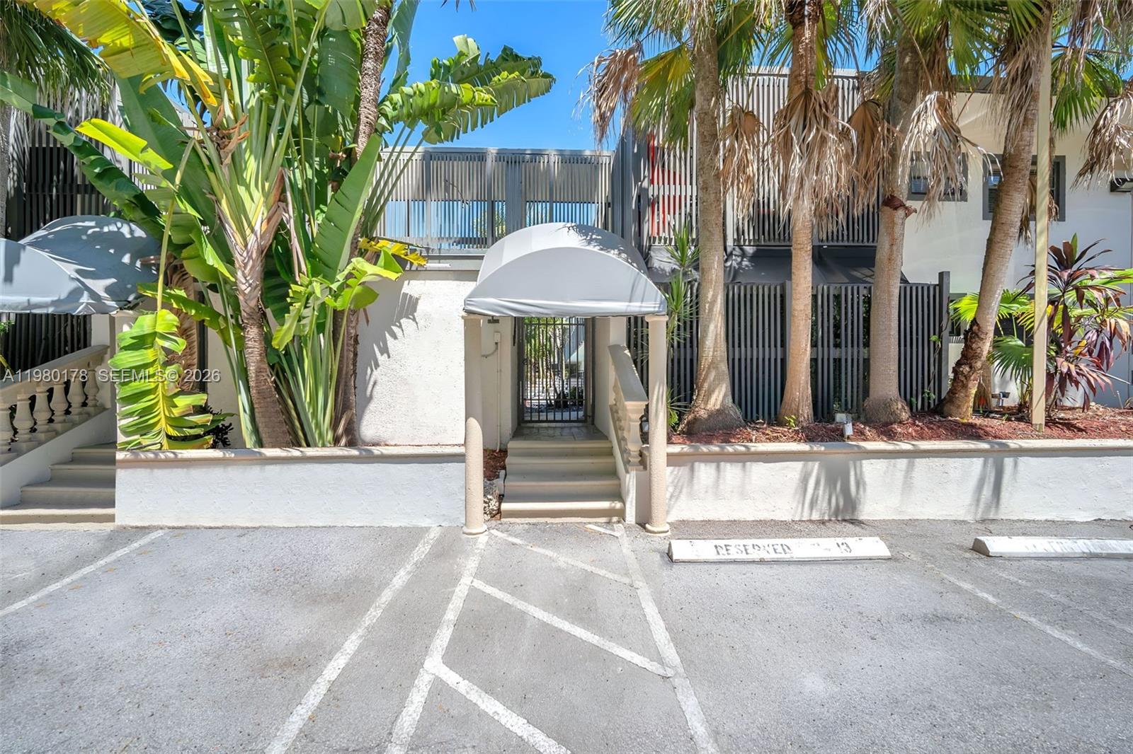 3265 Virginia Street, Unit 9 Miami, FL 33133 - Photo 24 of 32 a view of a dinning table and chairs in patio