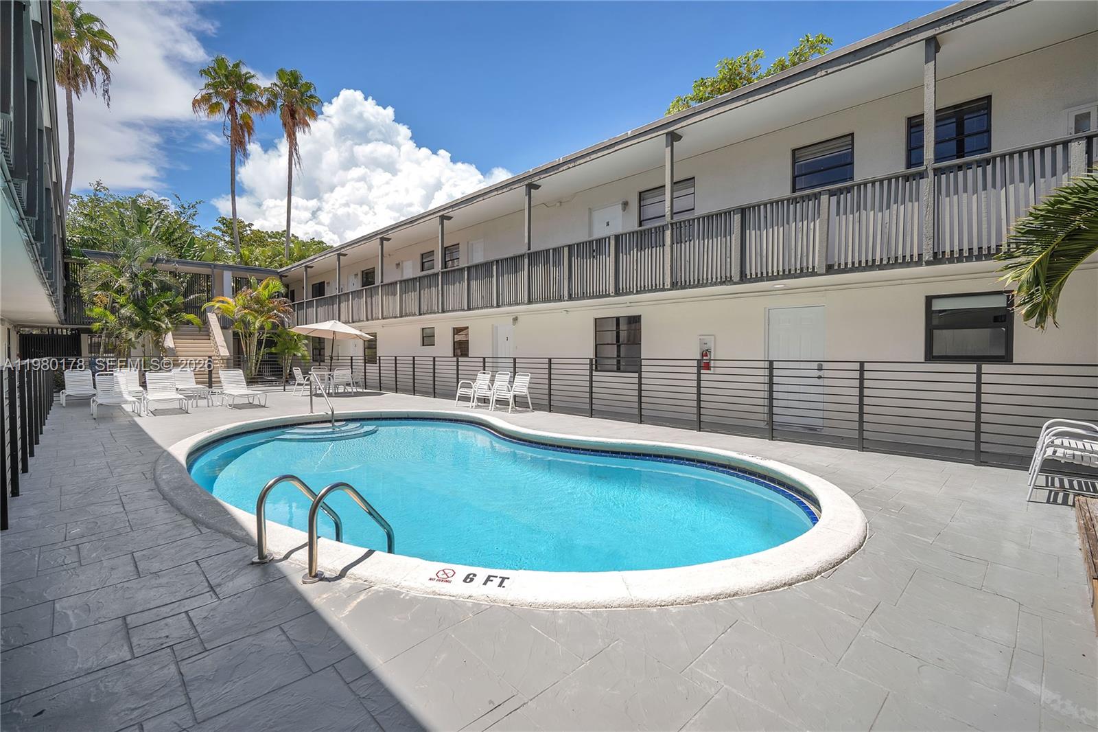 3265 Virginia Street, Unit 9 Miami, FL 33133 - Photo 25 of 32 a view of a swimming pool with a patio