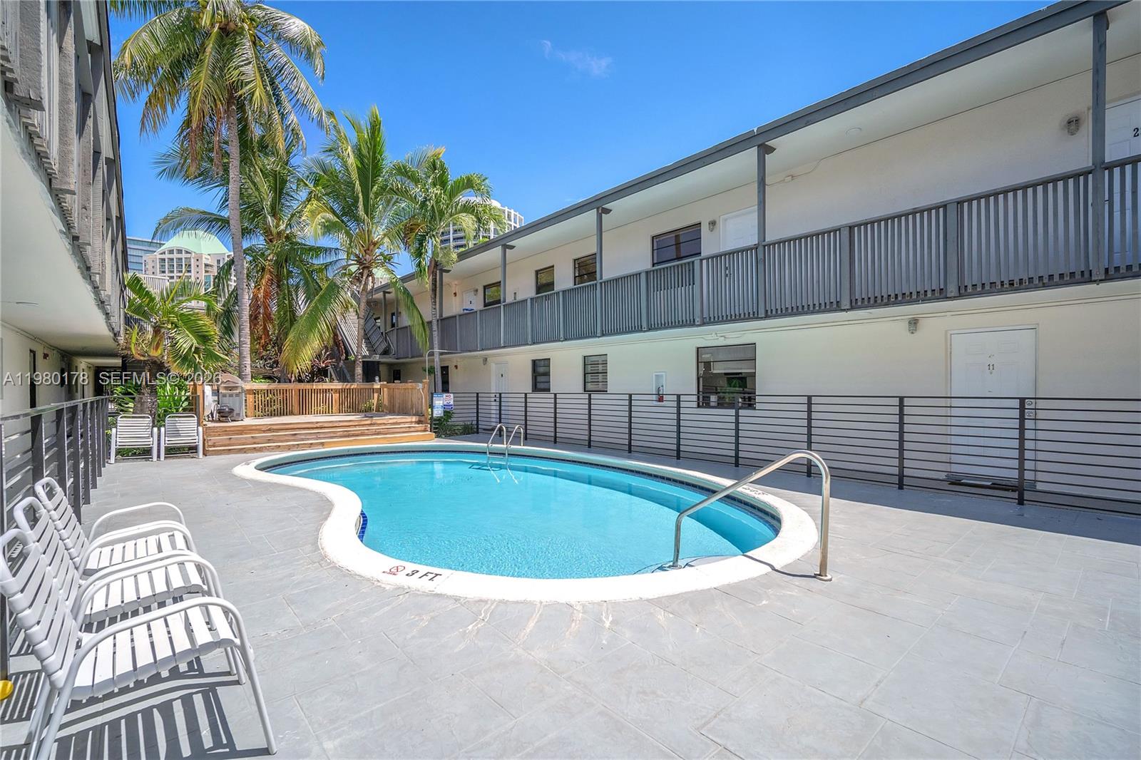 3265 Virginia Street, Unit 9 Miami, FL 33133 - Photo 30 of 32 a swimming pool with outdoor seating and yard