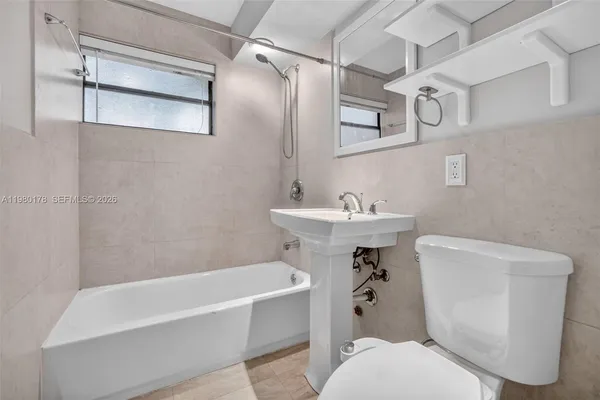 a bathroom with a sink a toilet and a bathtub