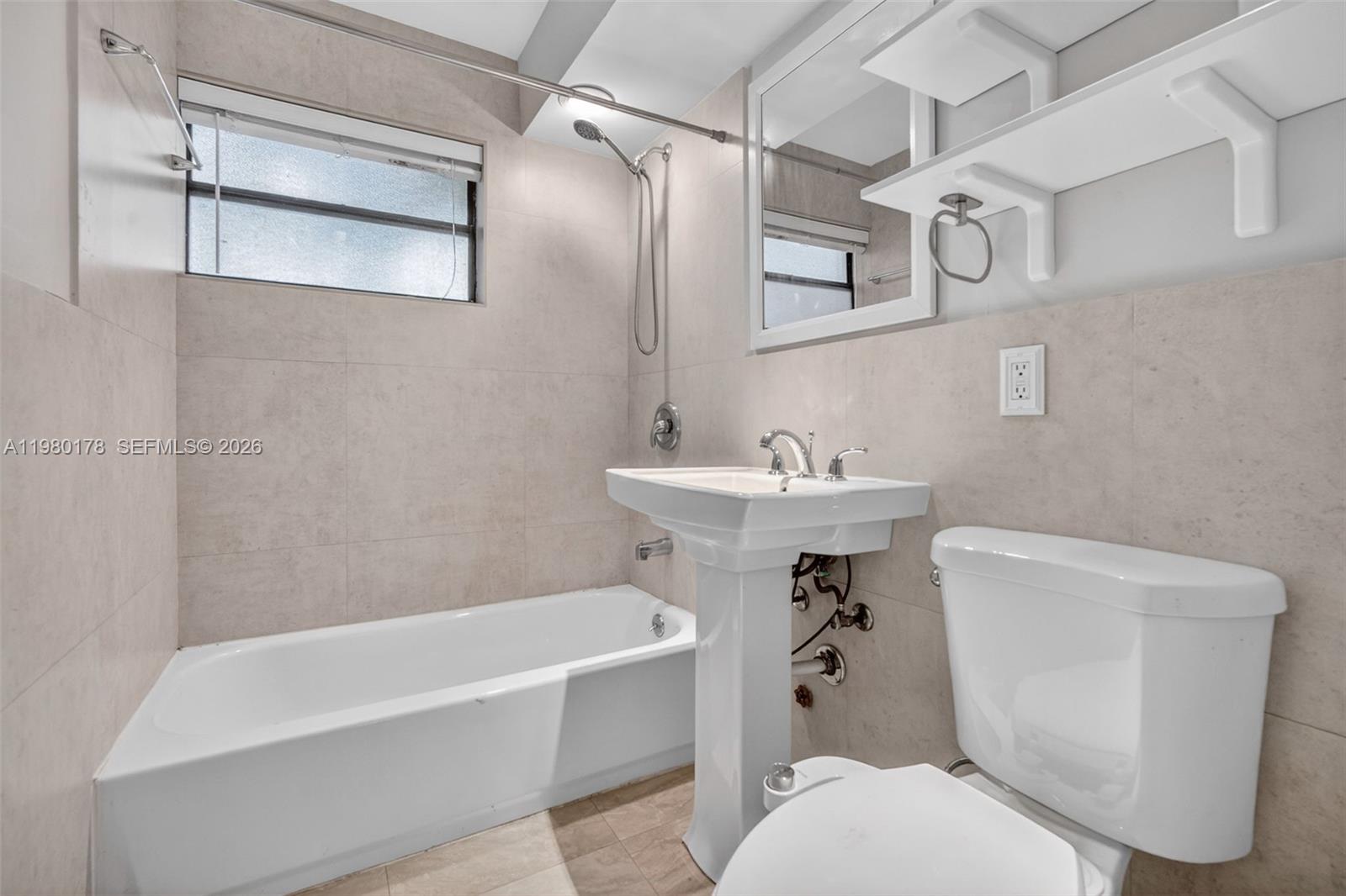 3265 Virginia Street, Unit 9 Miami, FL 33133 - Photo 3 of 32 a bathroom with a sink a toilet and a bathtub