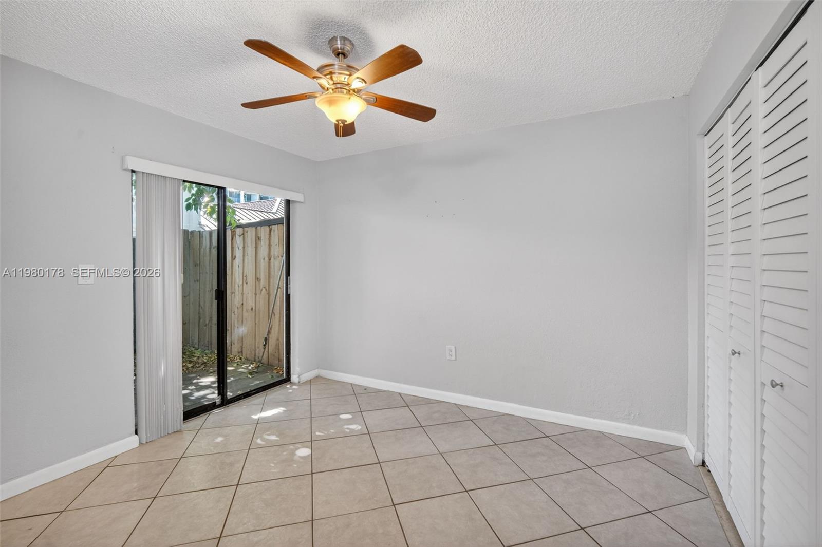 3265 Virginia Street, Unit 9 Miami, FL 33133 - Photo 4 of 32 an empty room with closet and a chandelier fan