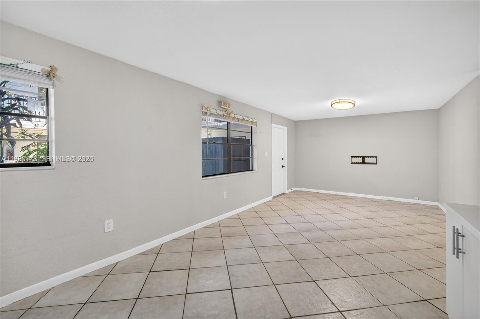 3265 Virginia Street, Unit 9 Miami, FL 33133 - Photo 7 of 32 a view of an empty room and window