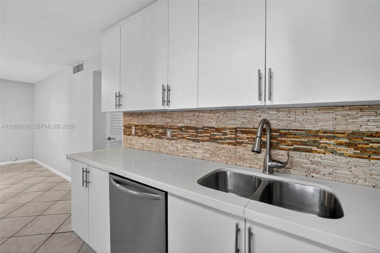 3265 Virginia Street, Unit 9 Miami, FL 33133 - Photo 8 of 32 a view with kitchen island sink and refrigerator