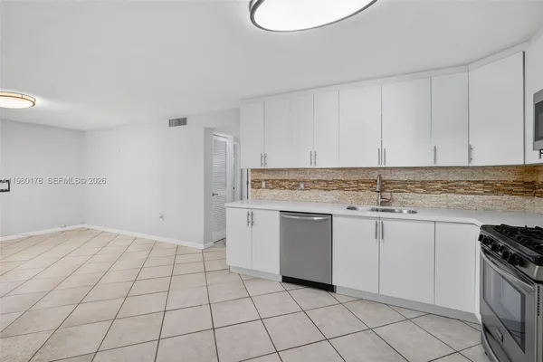a view of kitchen with white cabinets