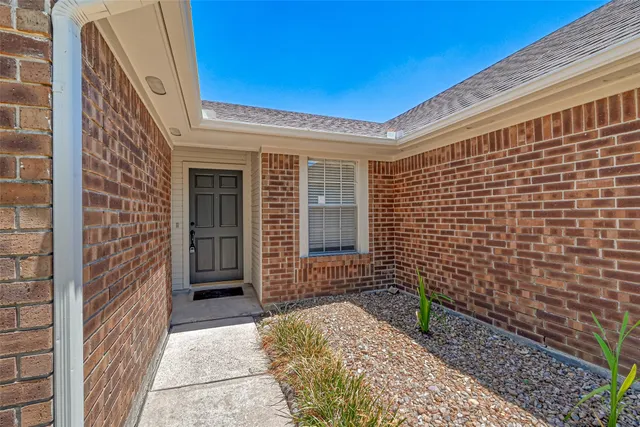 a view of a brick house with a large door