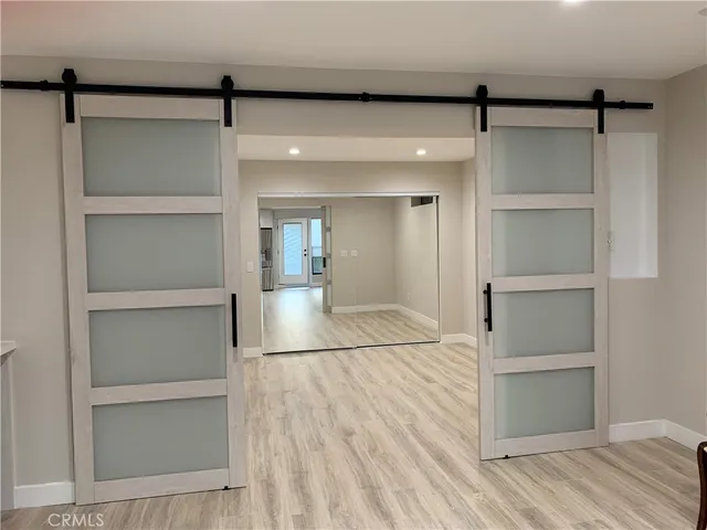 a room with walk in closet and wooden floor