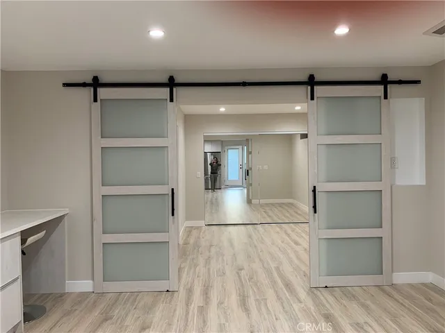 a view of a room with wooden floor