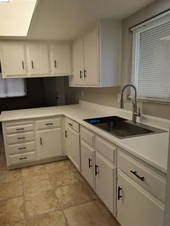 a kitchen with appliances cabinets and a sink