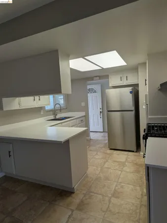 a kitchen with a sink and a refrigerator