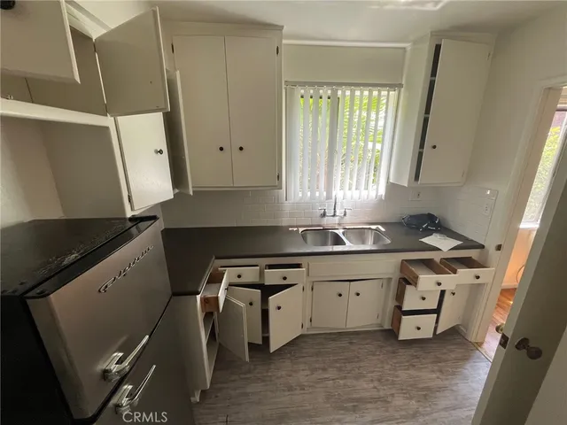 a kitchen with stainless steel appliances a stove a refrigerator and cabinets