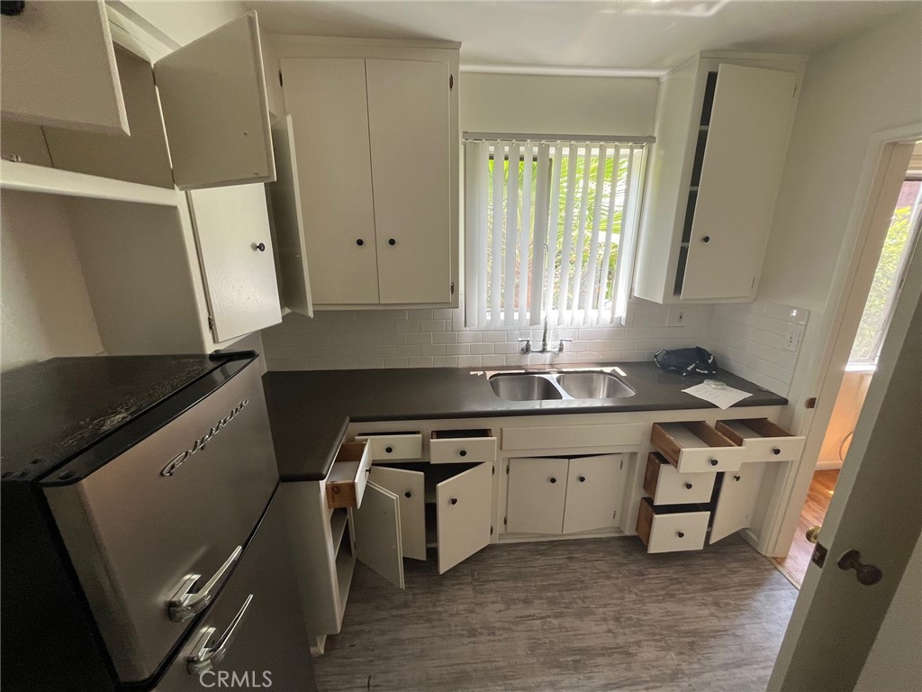 1142 Western Avenue Glendale, CA 91201 - Photo 15 of 23 a kitchen with a sink stove and cabinets
