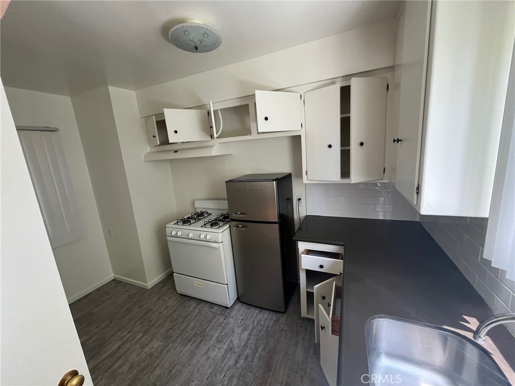 1142 Western Avenue Glendale, CA 91201 - Photo 16 of 23 a kitchen with stainless steel appliances a stove a refrigerator and cabinets