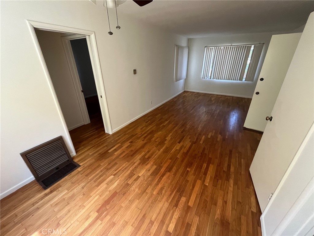 1142 Western Avenue Glendale, CA 91201 - Photo 17 of 23 a view of an empty room with wooden floor and a window