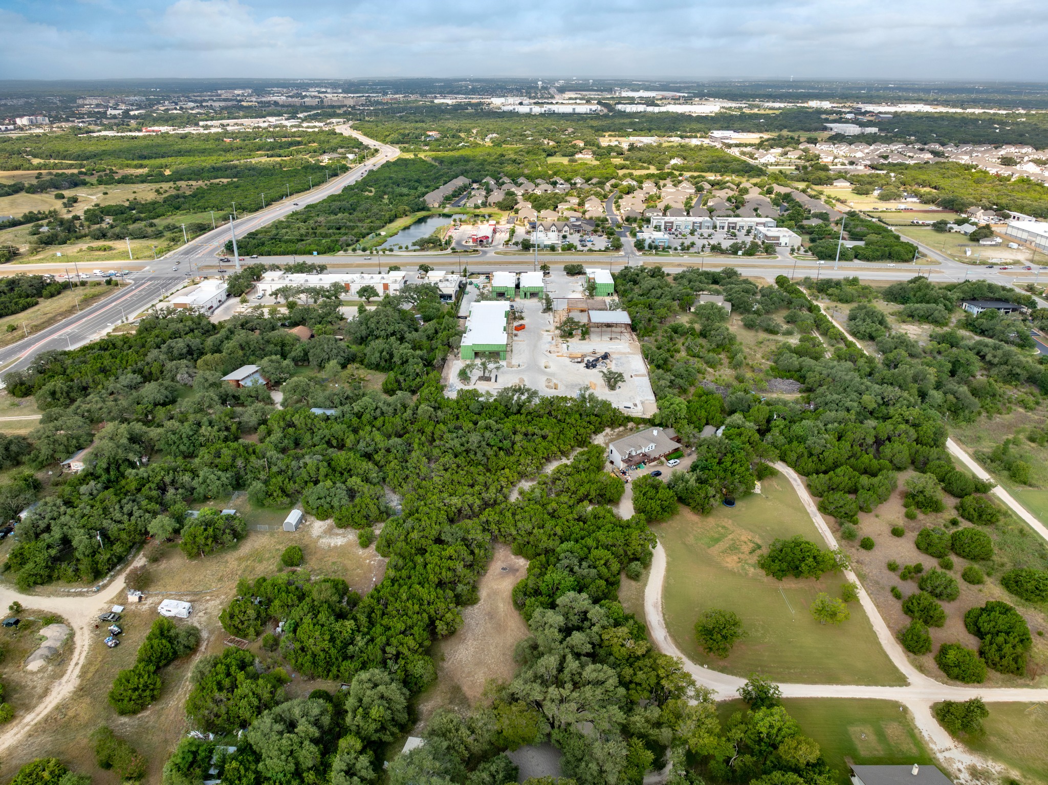 5021 Little Valley Road Leander, TX 78641 - Photo 31 of 32 Aerial view of a grassy clearing enclosed by mature tree cover.