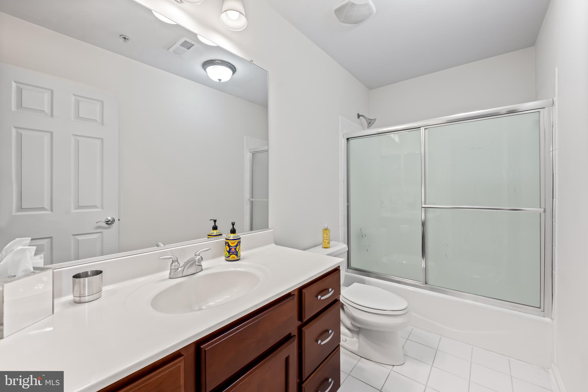 2618 Lighthouse Lane Baltimore, MD 21224 - Photo 29 of 60 a bathroom with a sink toilet vanity and shower