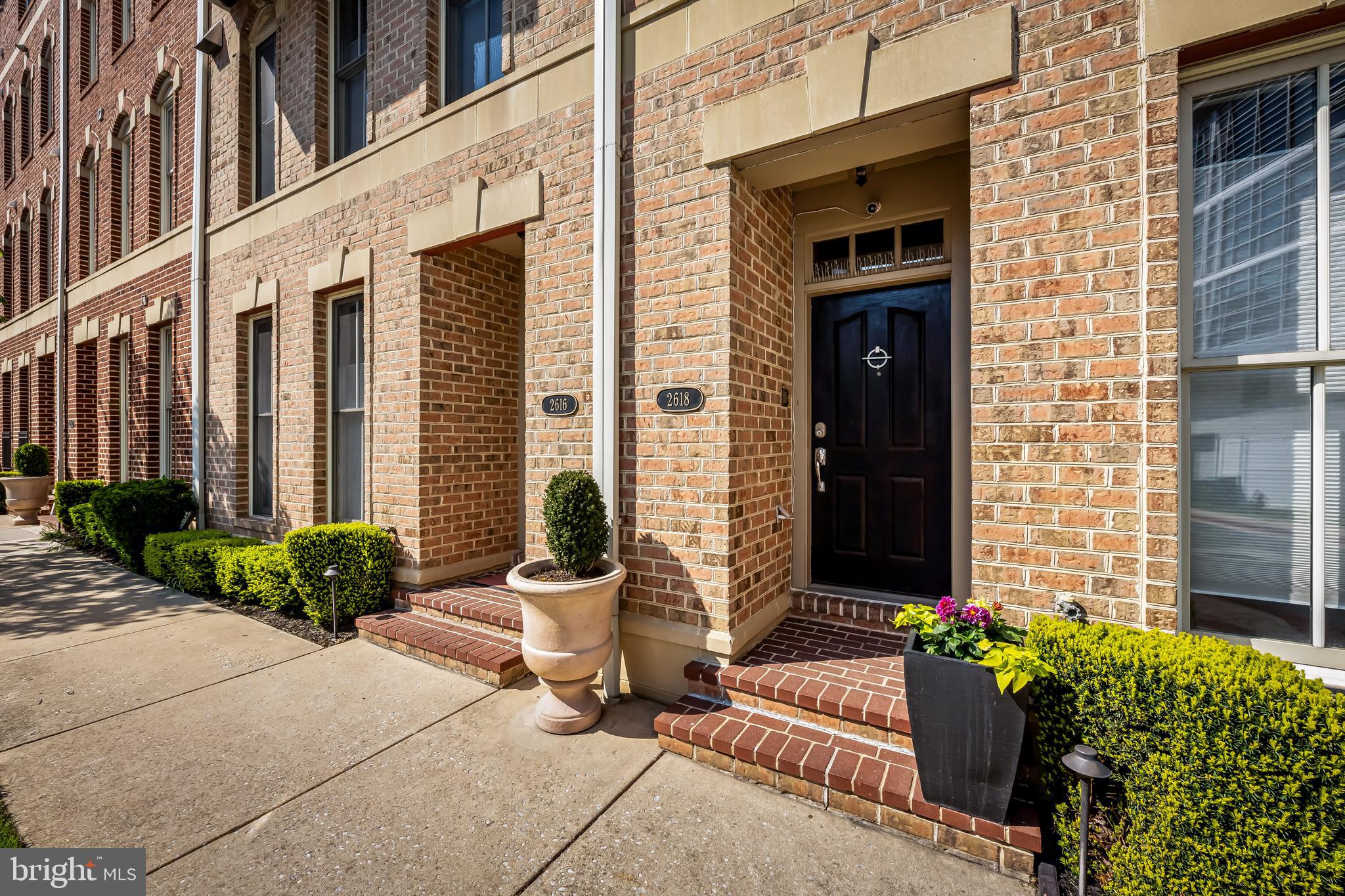 2618 Lighthouse Lane Baltimore, MD 21224 - Photo 3 of 60 a view of a brick house with potted plants and a potted plant