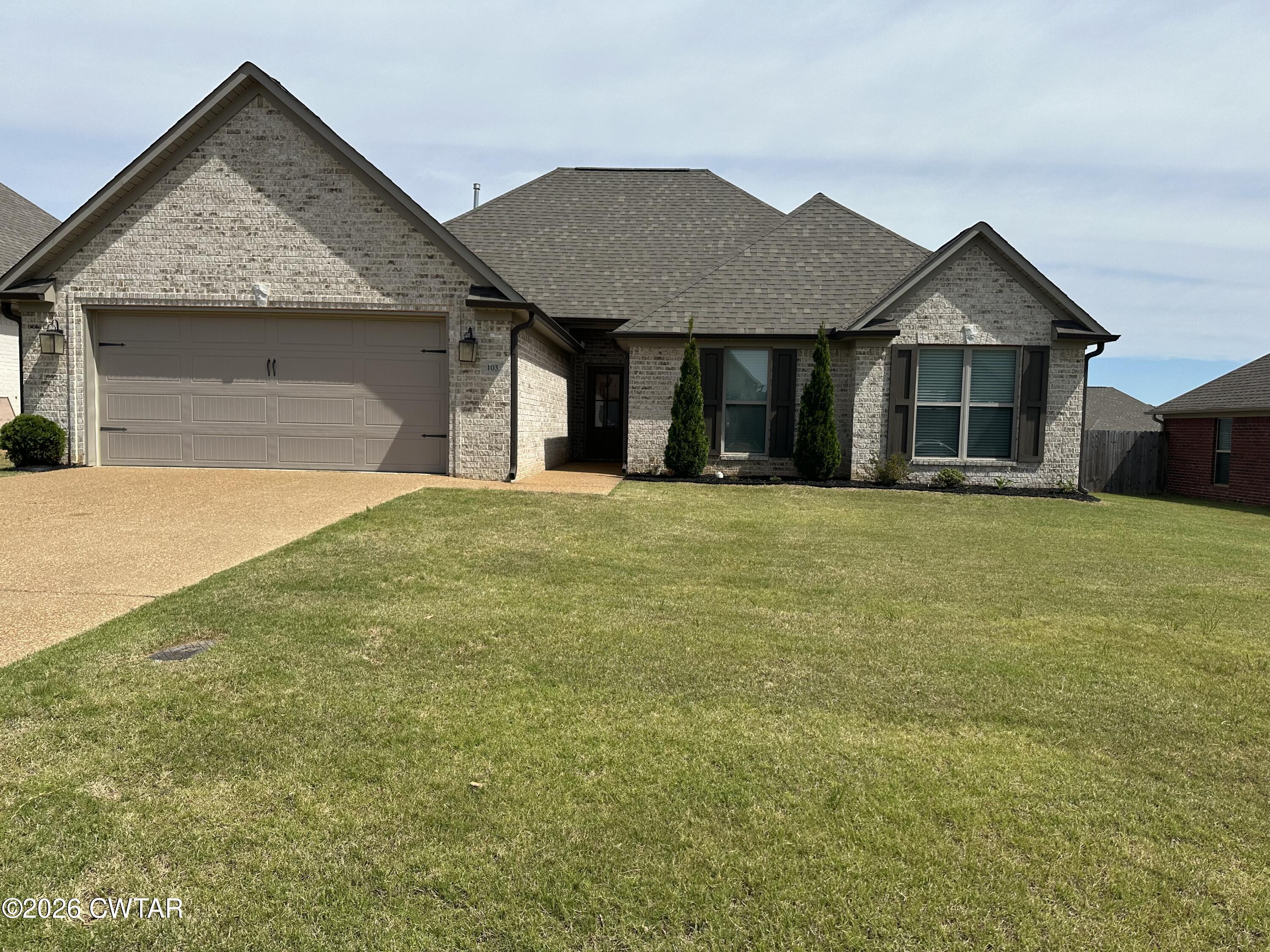 103 Gatewick Drive Jackson, TN 38305 - Photo 1 of 29 a view of a house with a yard and garage