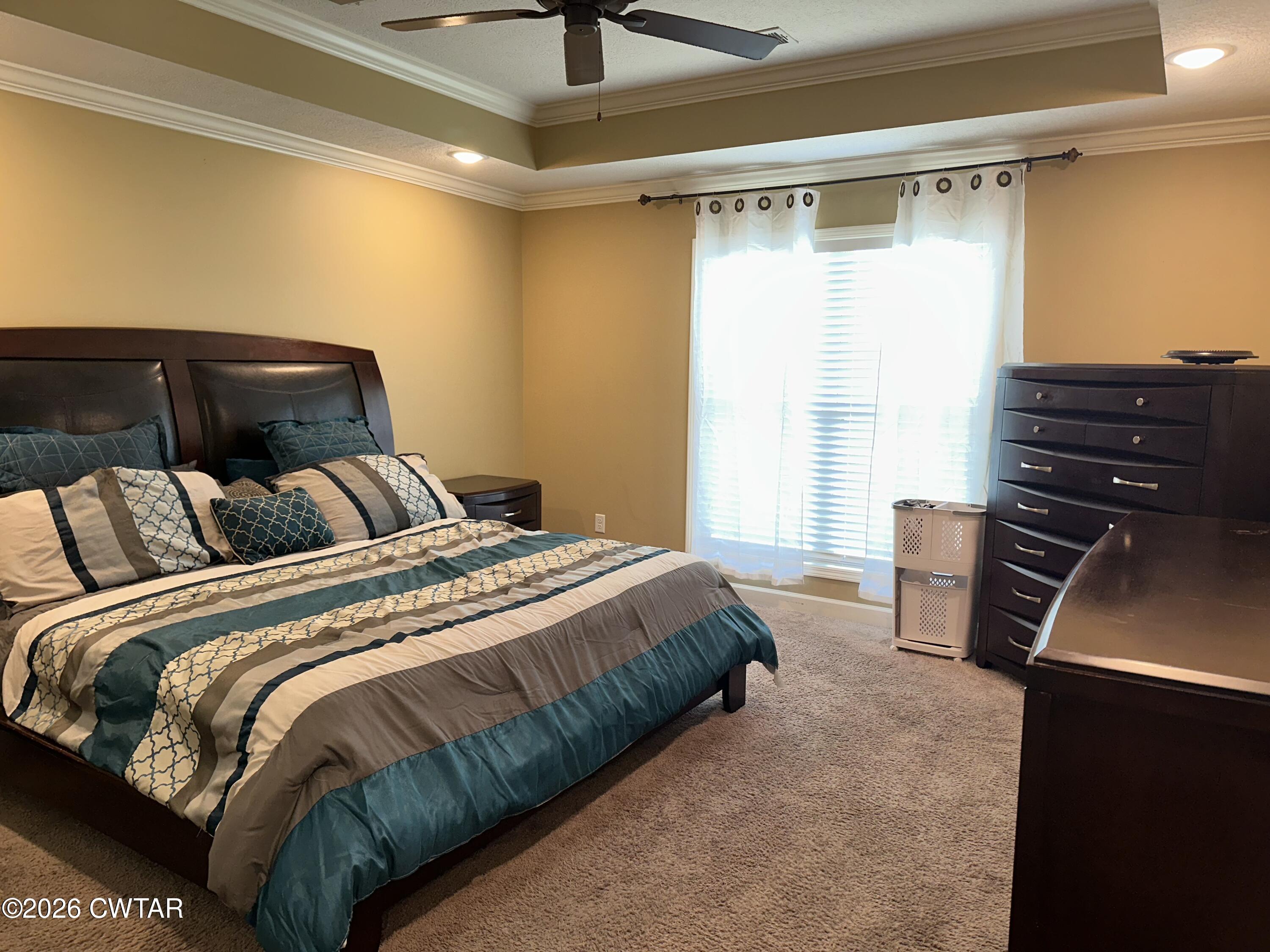 103 Gatewick Drive Jackson, TN 38305 - Photo 11 of 29 a bedroom with a bed and a dresser