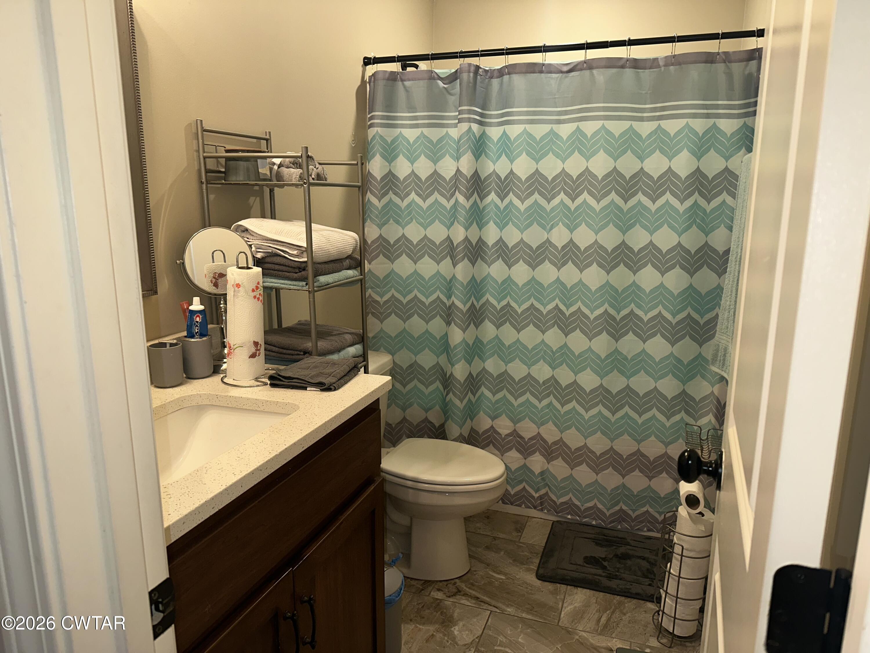 103 Gatewick Drive Jackson, TN 38305 - Photo 19 of 29 a bathroom with a granite countertop sink toilet and shower
