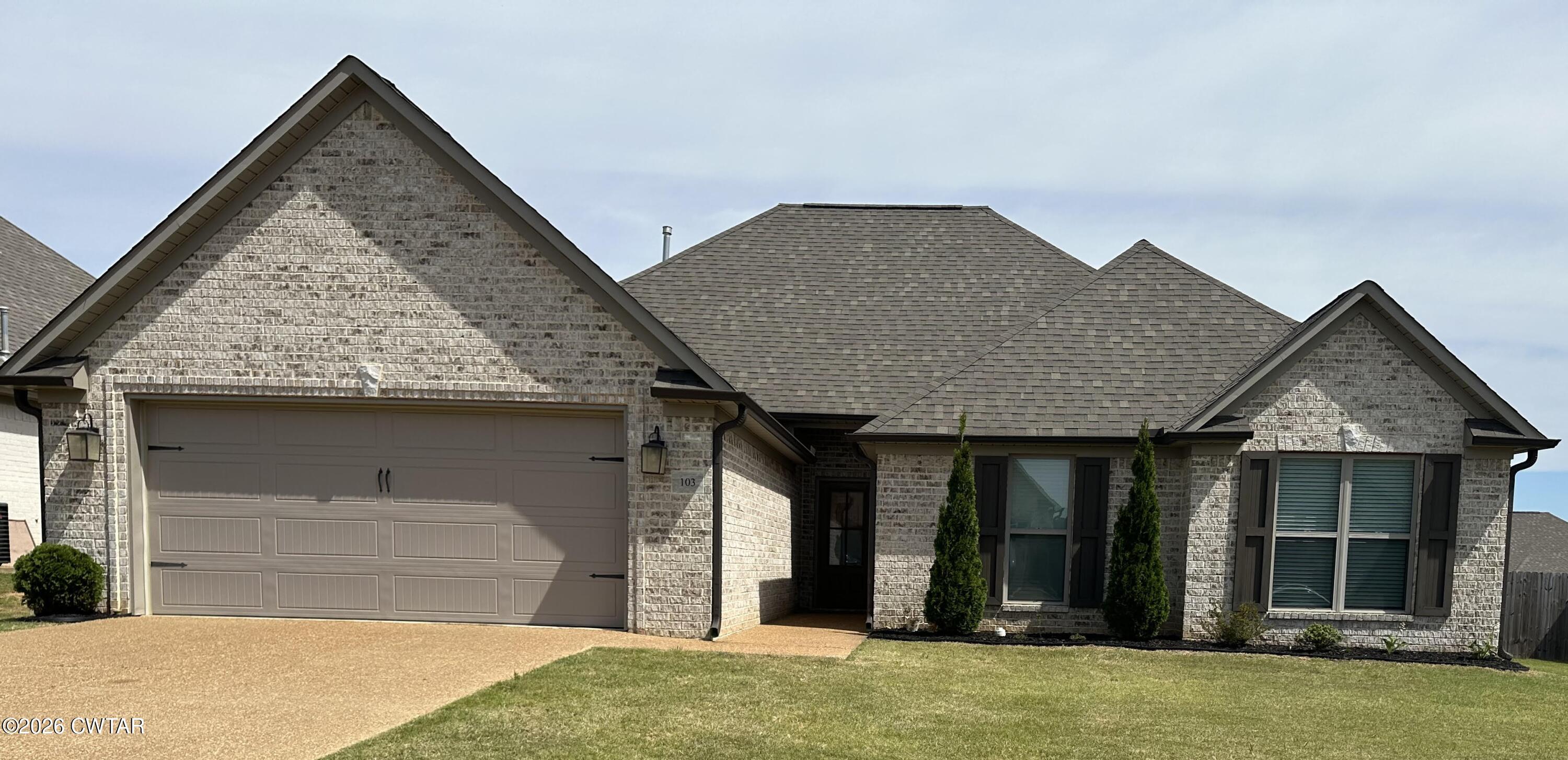 103 Gatewick Drive Jackson, TN 38305 - Photo 2 of 29 a front view of a house with a garden