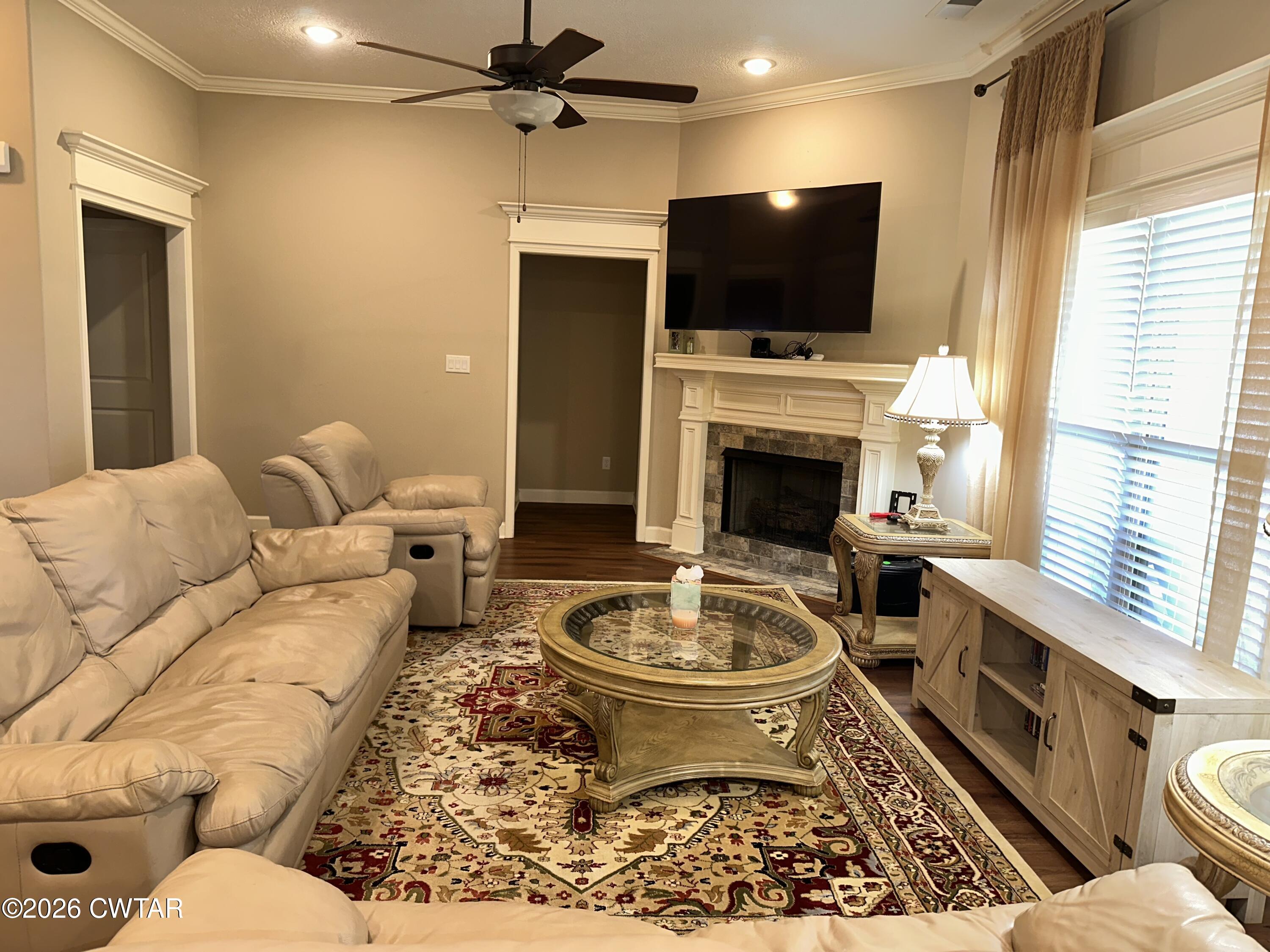 103 Gatewick Drive Jackson, TN 38305 - Photo 4 of 29 a living room with furniture a flat screen tv and a fireplace