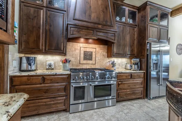 a kitchen with granite countertop a stove and a refrigerator