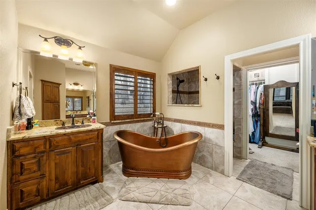 a living room with stainless steel appliances granite countertop a sink and a refrigerator
