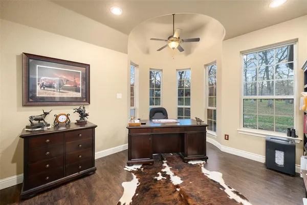 a view of workspace with wooden floor and windows