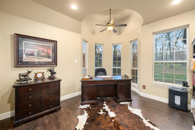 a view of workspace with wooden floor and windows