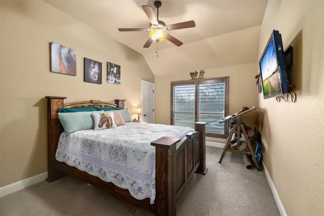 a bed room with a bed and a flat tv screen