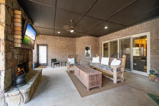 a balcony with furniture and a fireplace