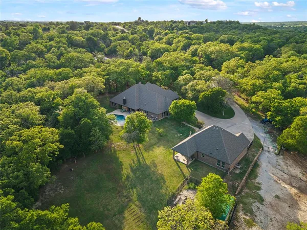 an aerial view of a house with yard