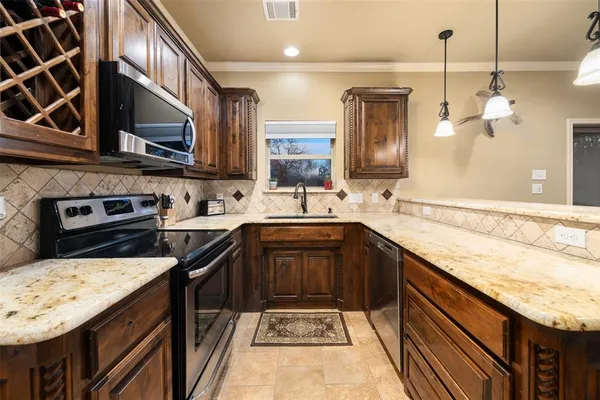 a kitchen with a sink stove and microwave