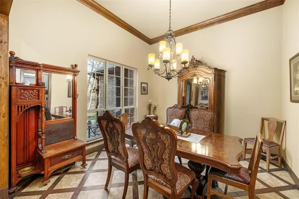 a view of a dining room with furniture and a chandelier