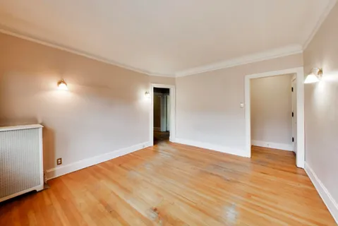a view of an empty room and wooden floor