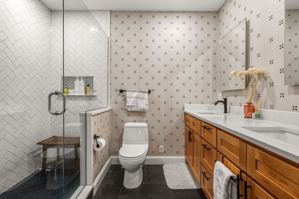 753 East Broadway, Unit 2A Boston, MA 02127 - Photo 10 of 17 a bathroom with a toilet sink and mirror