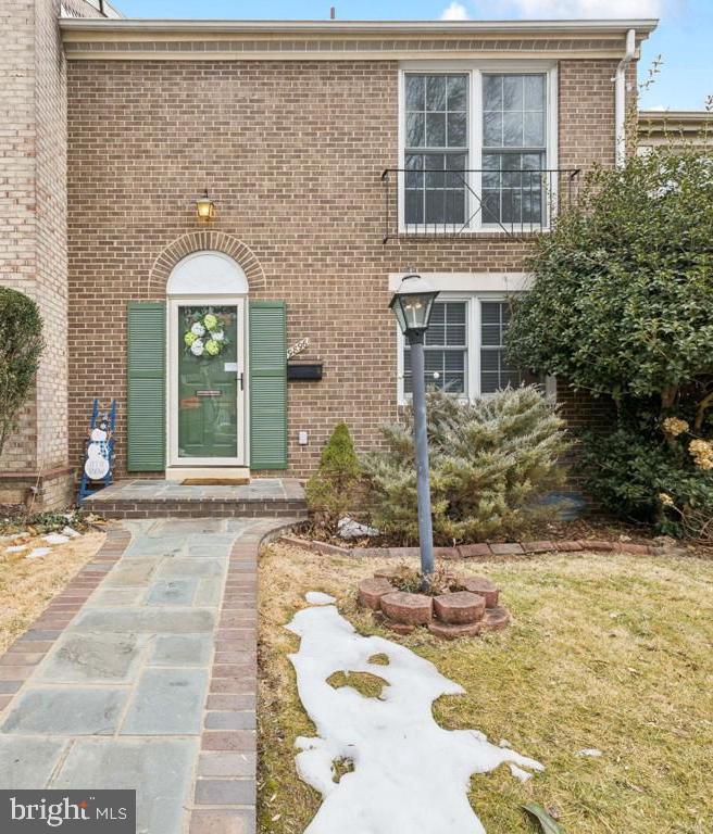 a view of a brick house with potted plants