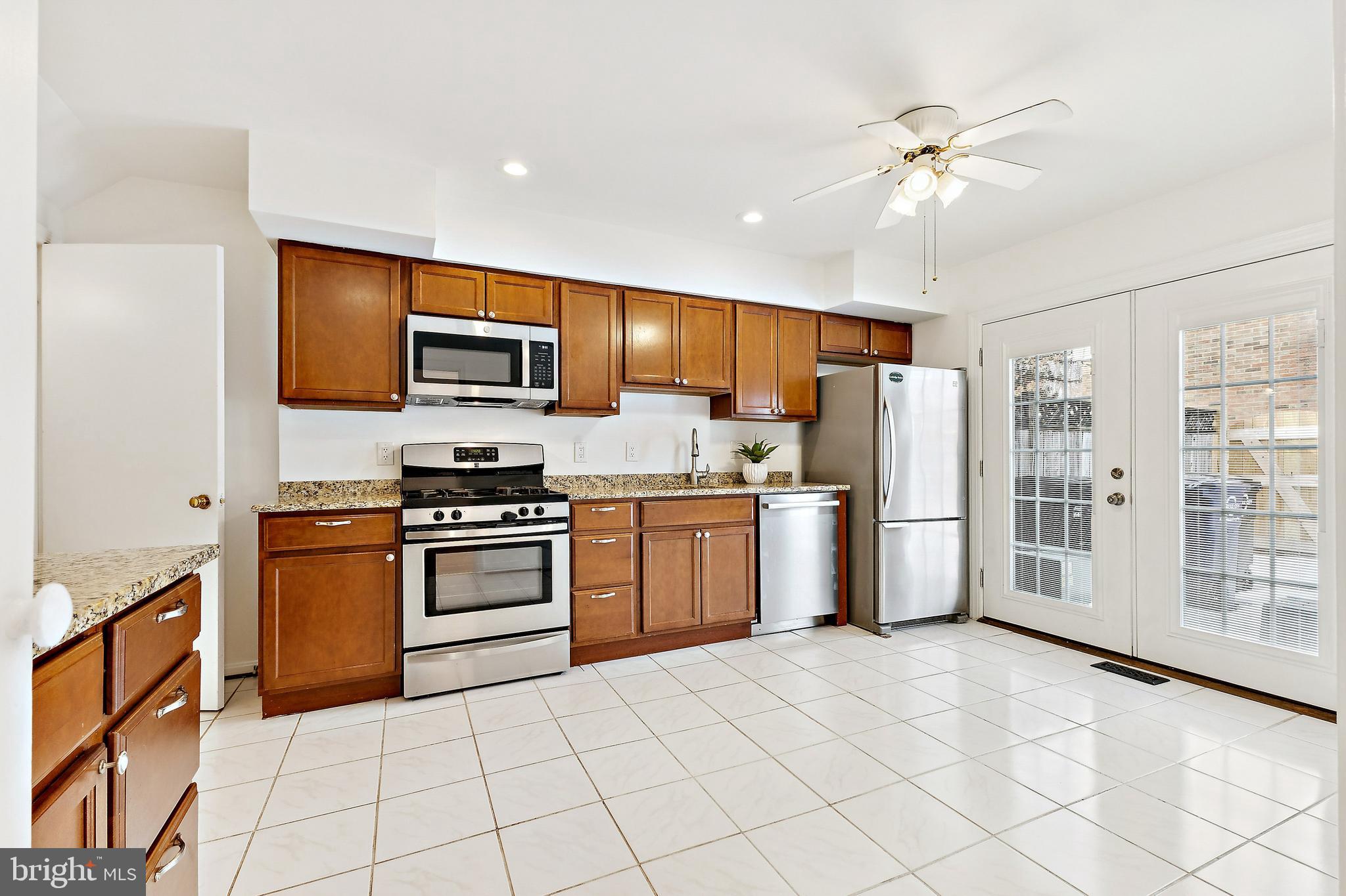 9896 Cardinal Road Fairfax, VA 22030 - Photo 12 of 44 a kitchen with stainless steel appliances granite countertop a refrigerator stove and sink