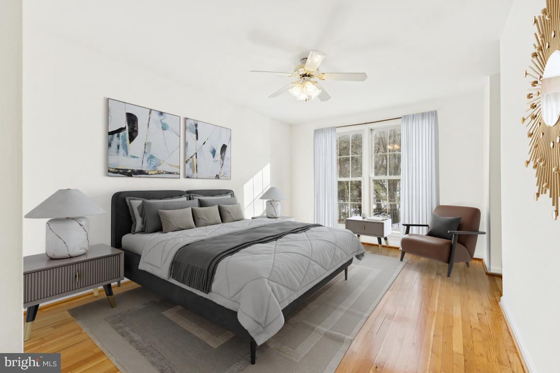 9896 Cardinal Road Fairfax, VA 22030 - Photo 17 of 44 a bedroom with a bed and wooden floor