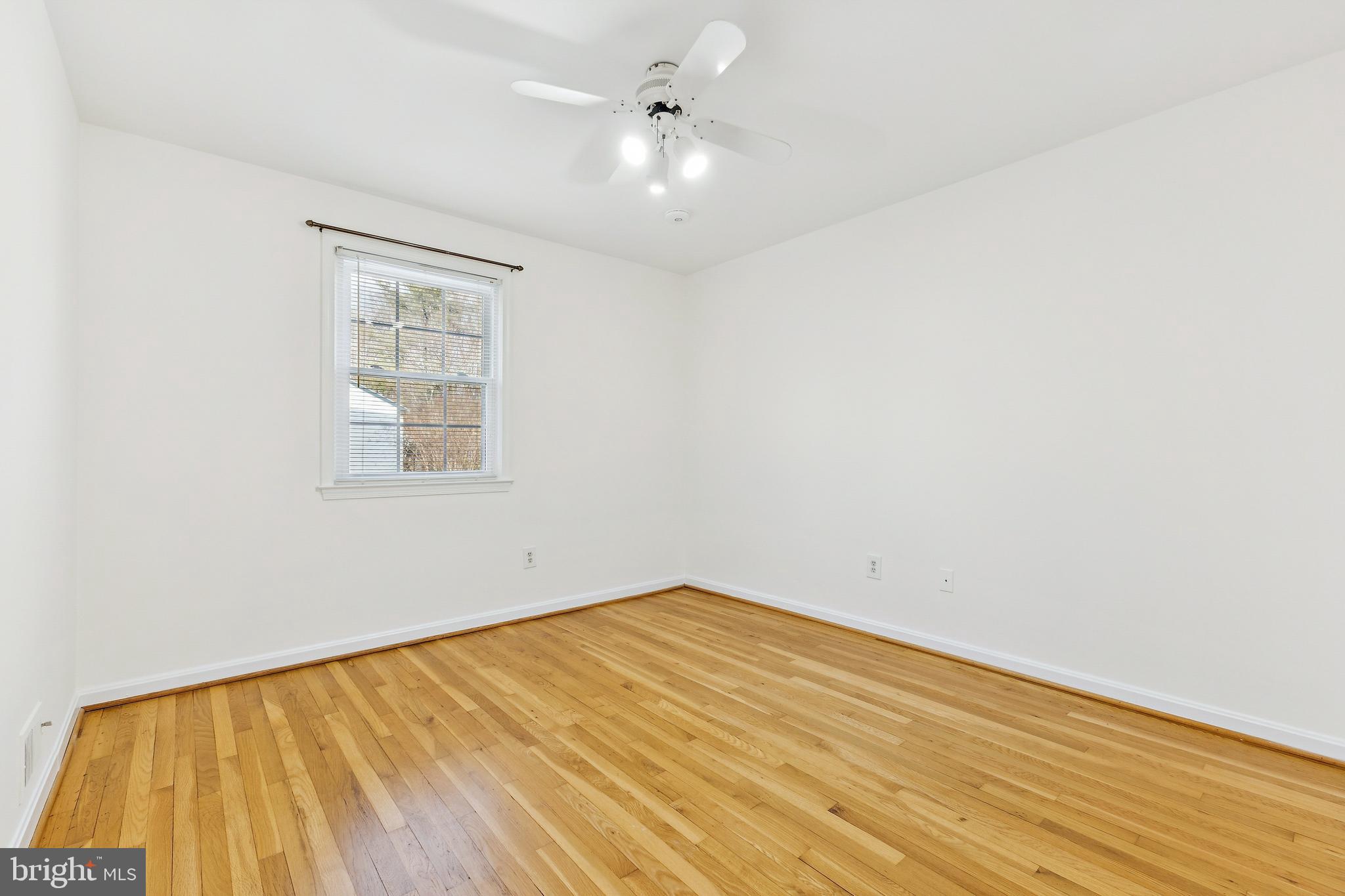 9896 Cardinal Road Fairfax, VA 22030 - Photo 22 of 44 an empty room with a window and ceiling fan