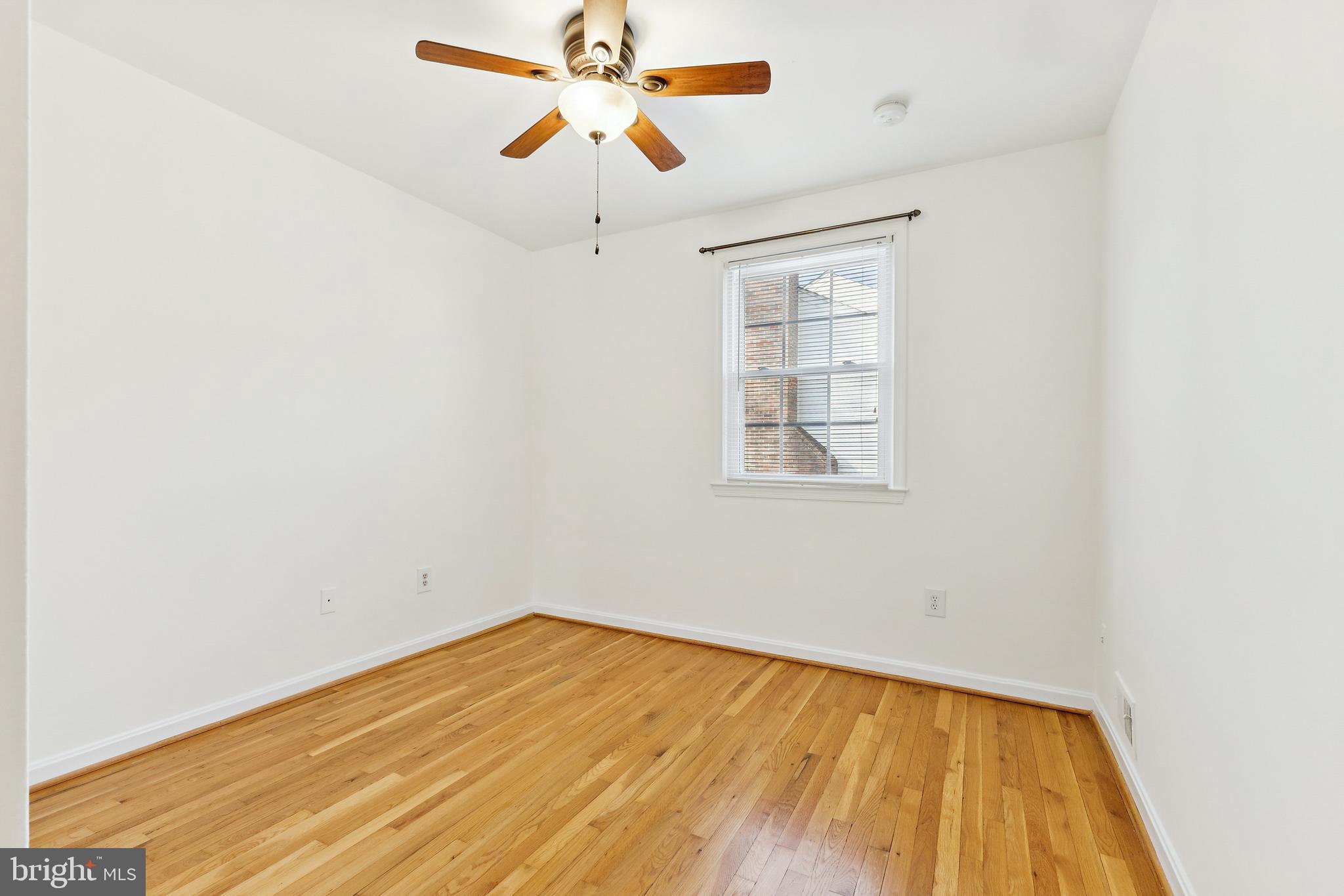 9896 Cardinal Road Fairfax, VA 22030 - Photo 25 of 44 an empty room with a window and a ceiling fan