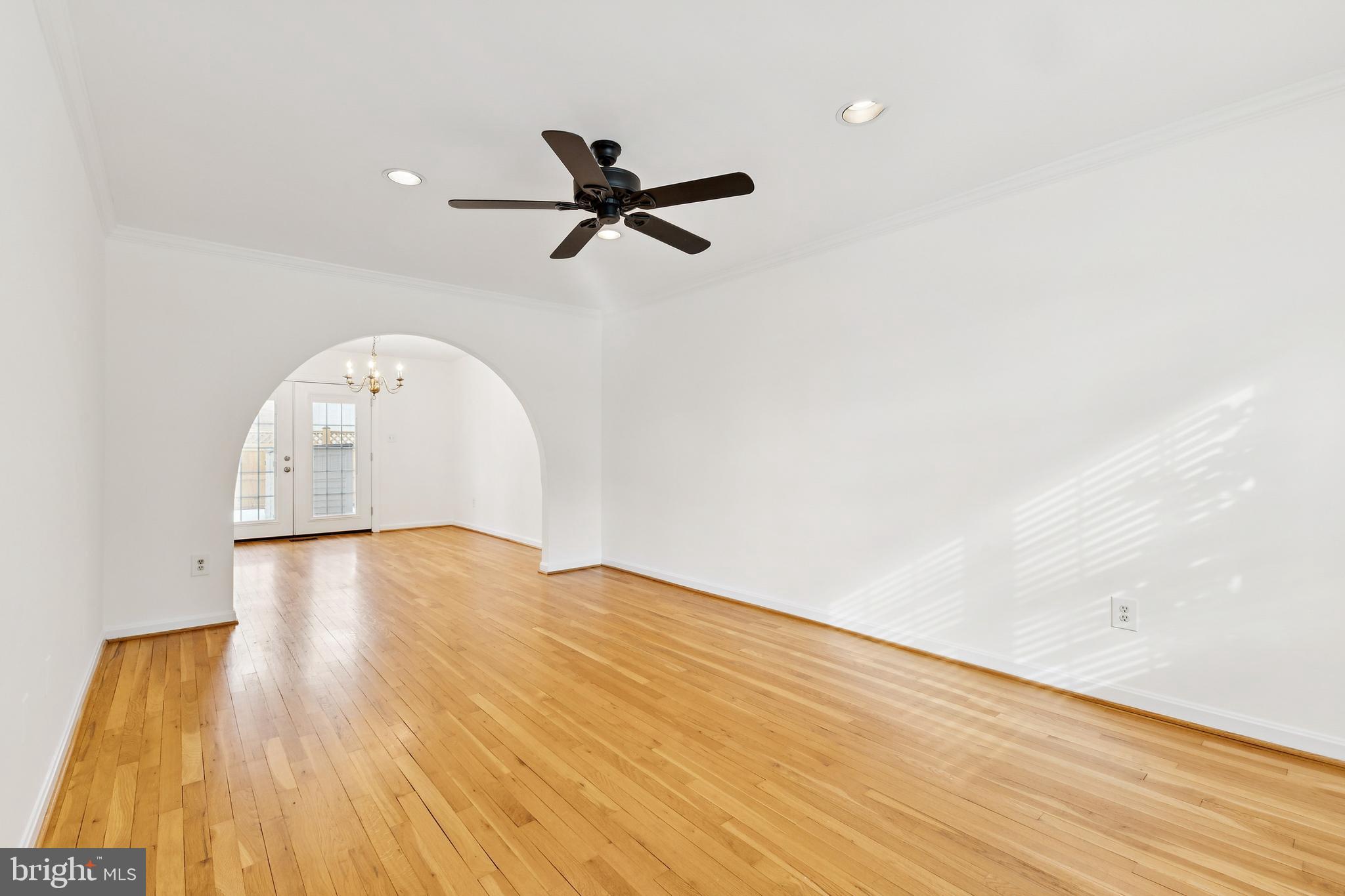 9896 Cardinal Road Fairfax, VA 22030 - Photo 5 of 44 a view of empty room with wooden floor and fan