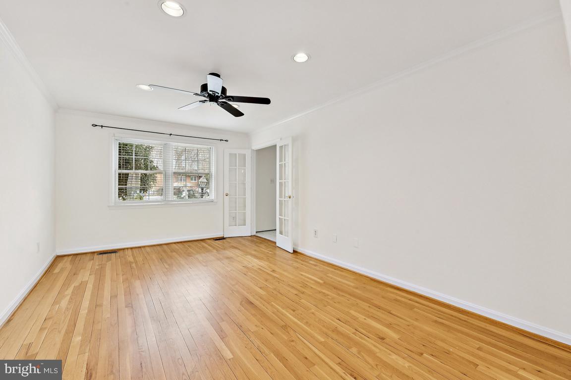 9896 Cardinal Road Fairfax, VA 22030 - Photo 6 of 44 an empty room with wooden floor ceiling fan and windows