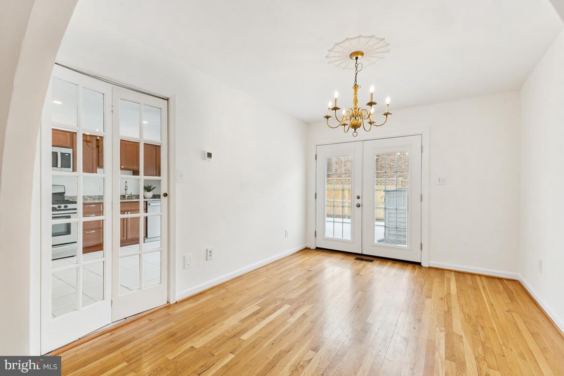 9896 Cardinal Road Fairfax, VA 22030 - Photo 10 of 44 a view of a room with wooden floor cabinet and windows