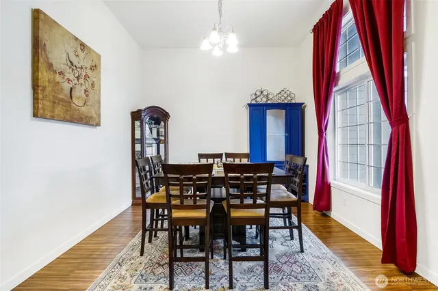 a view of a dining room with furniture and a window