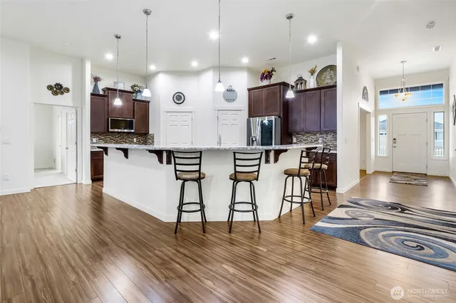 a large kitchen with lots of counter space and stainless steel appliances