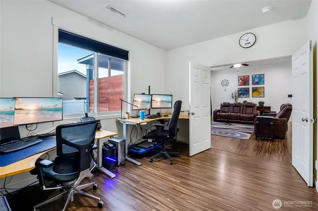a living room with furniture and wooden floor
